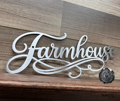 Decorative metal sign with 'Farmhouse' text on a wooden background