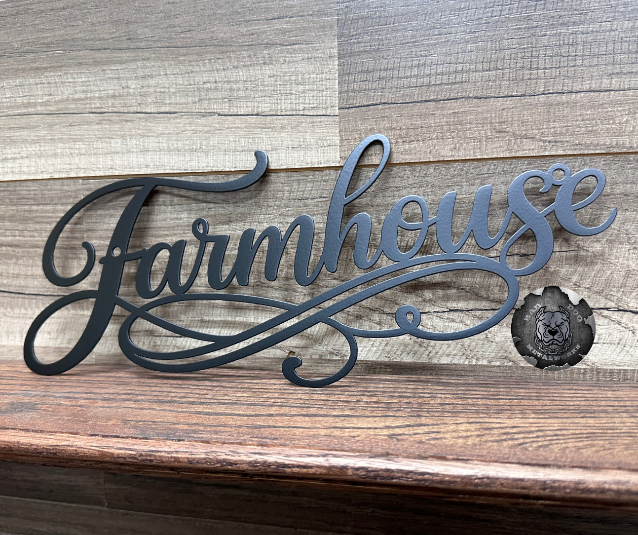 Metal 'Farmhouse' sign on a wooden background